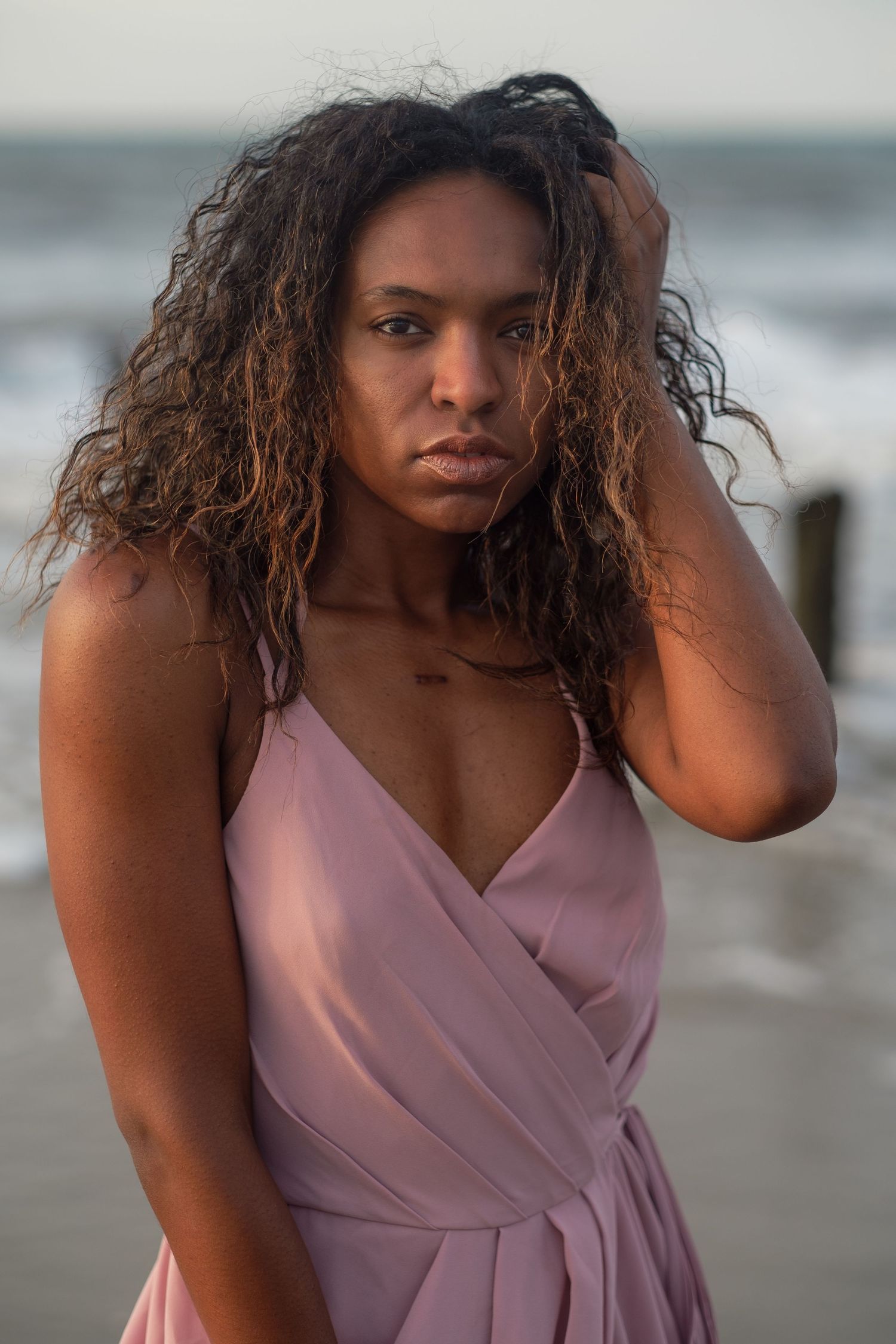 Charleston Folly Beach photoshoot of woman in elegant gown by the ocean