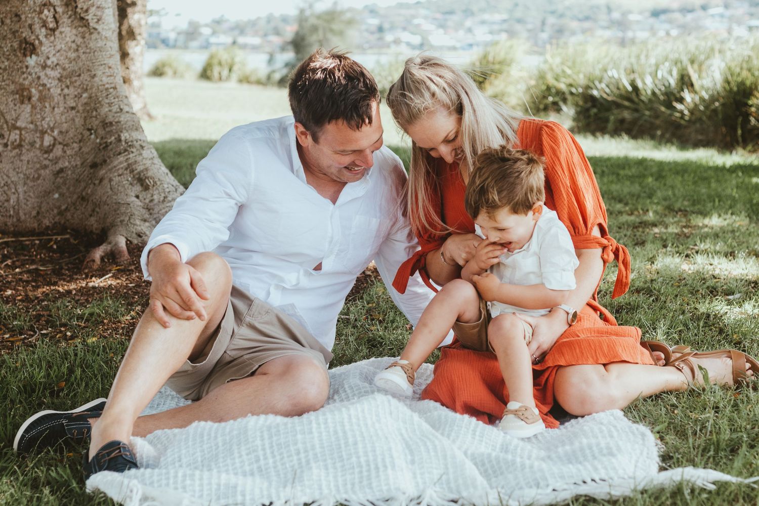Parenting tickling son at Bolton Point Park during Lake Macquarie family photoshoot