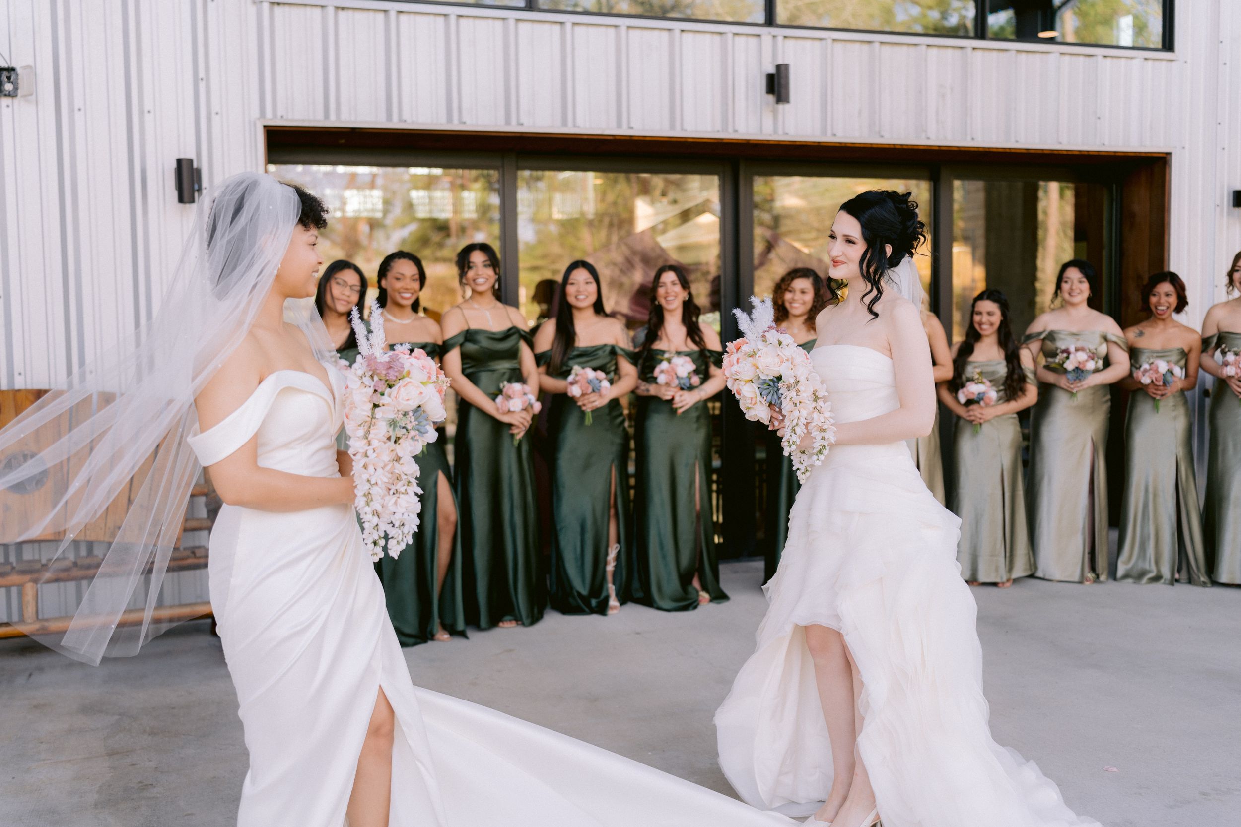 Wedding couple performs a choreographed dance move while bridesmaids in green dresses watch.