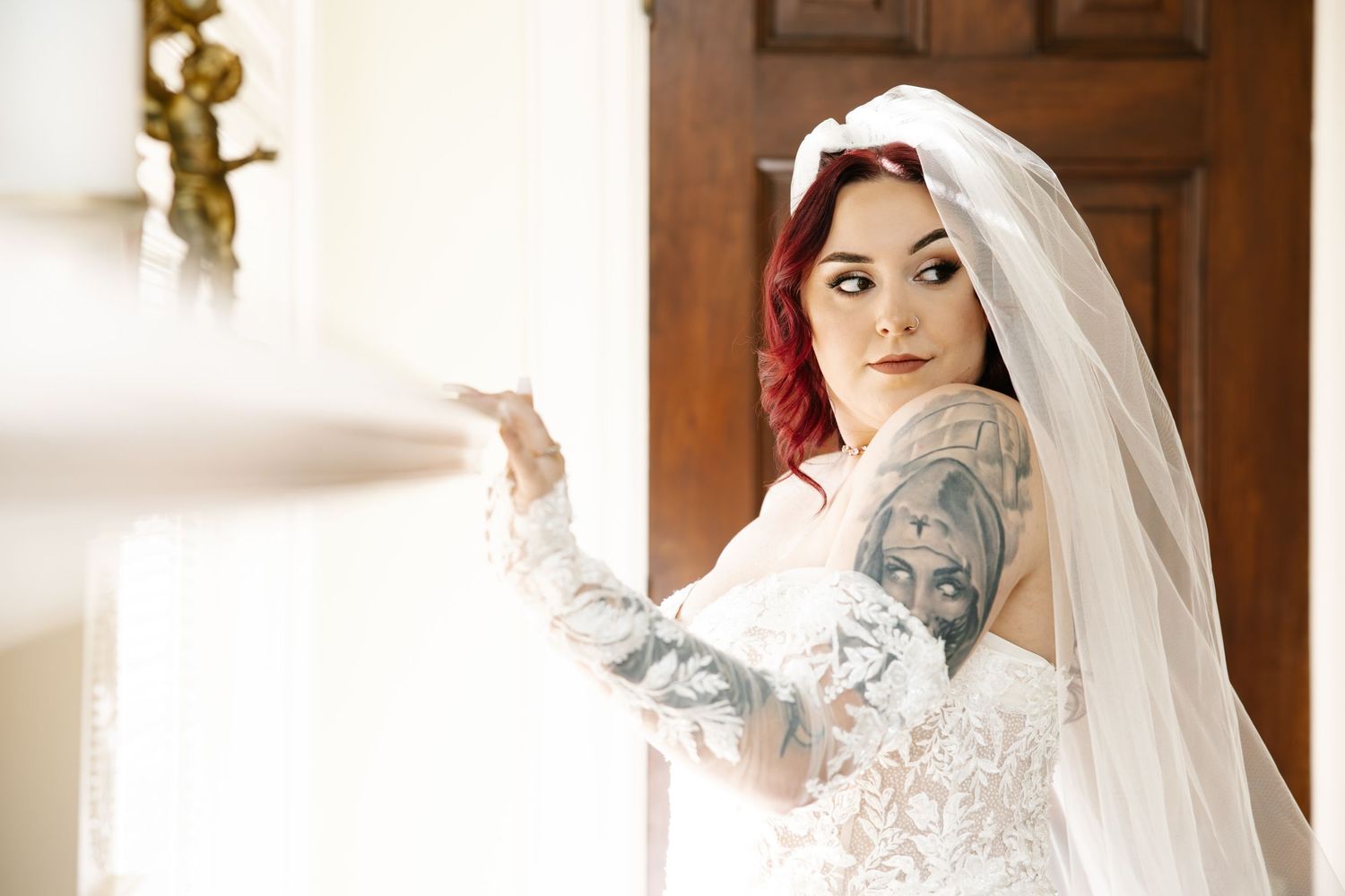 Bridal portrait photo shoot showcasing lace wedding dress details in warm lighting.