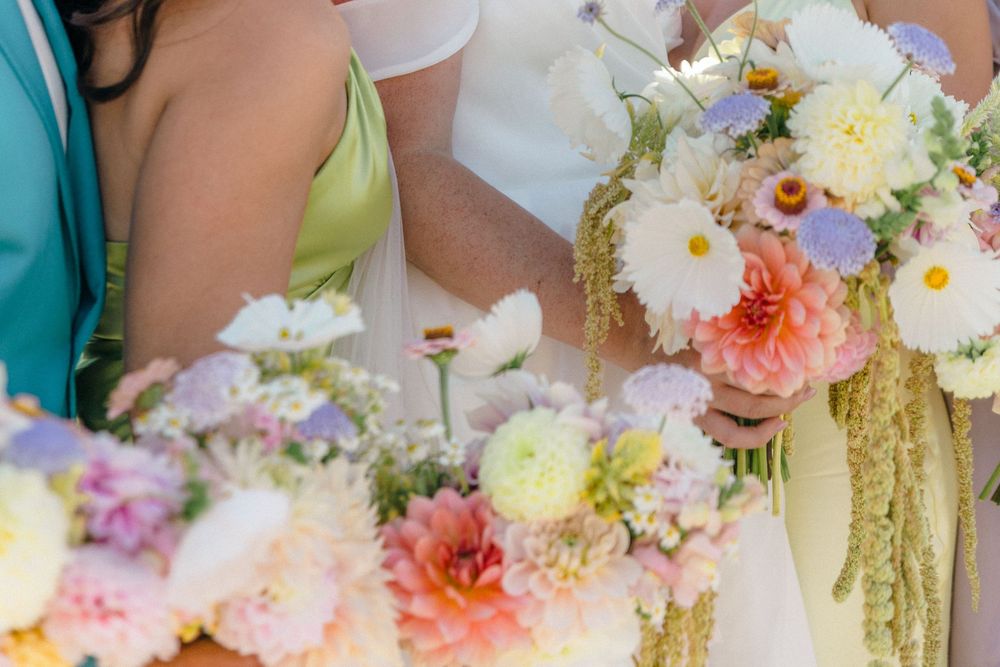Close-up of pastel wedding bouquets with dahlias, roses and trailing elements.Modern Wedding in the Okanagan