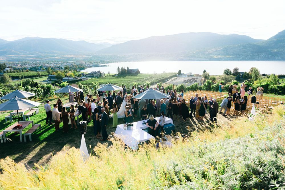 Panoramic view of a wedding ceremony overlooking a scenic mountain lake.