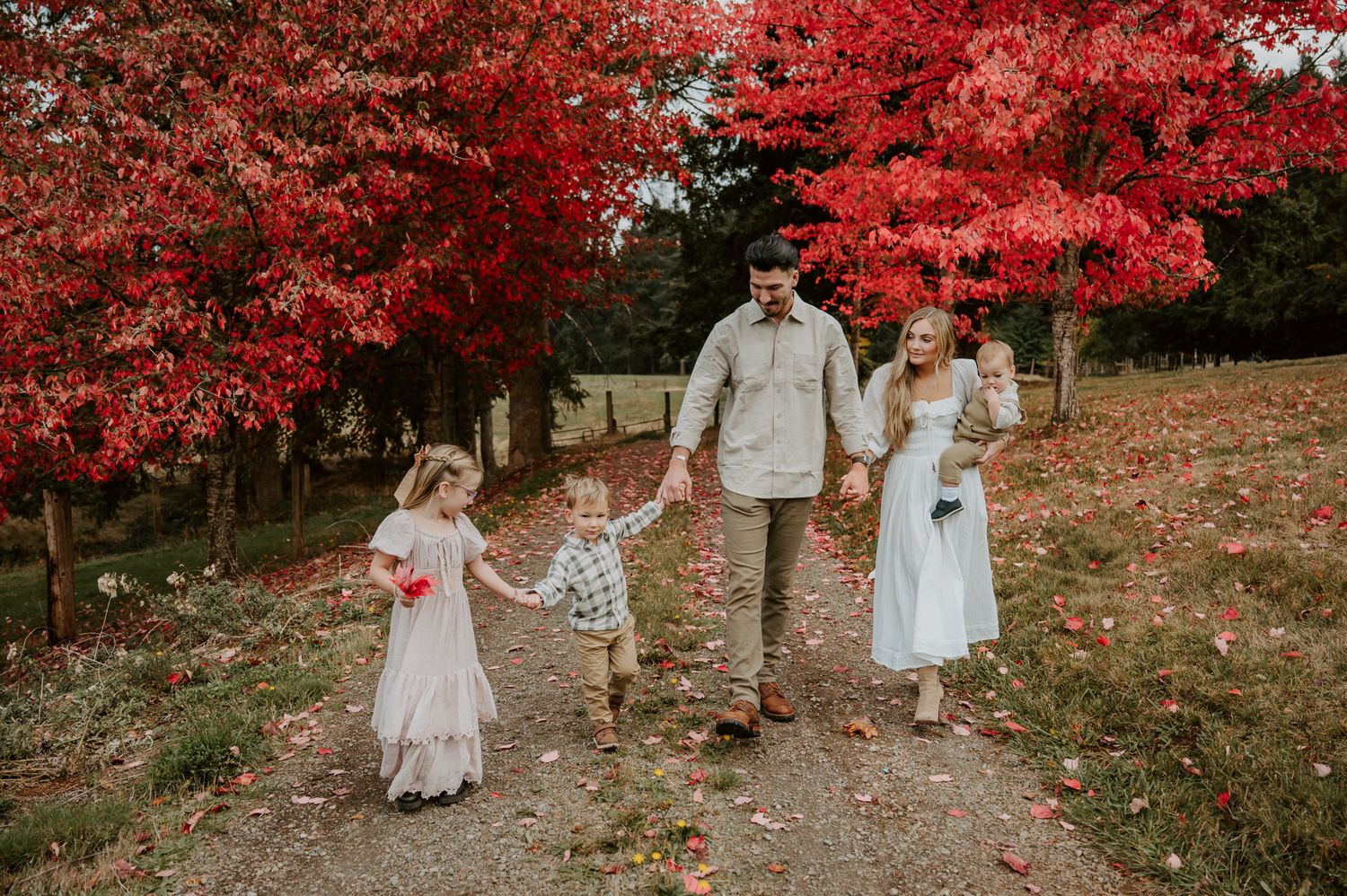 Child kneels beside her parents