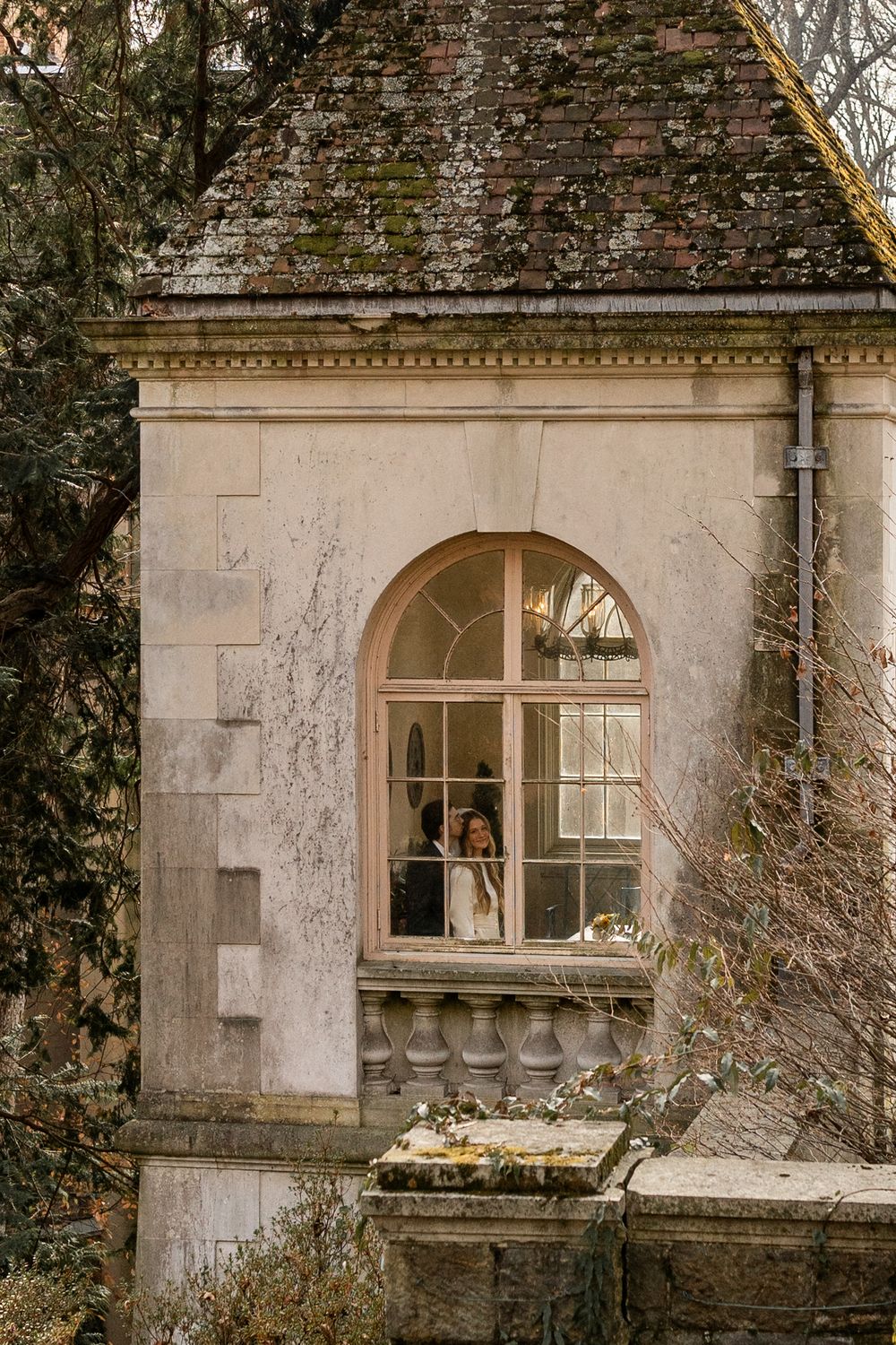 A series of old stone building windows with weathered walls and architectural details in a vintage style.