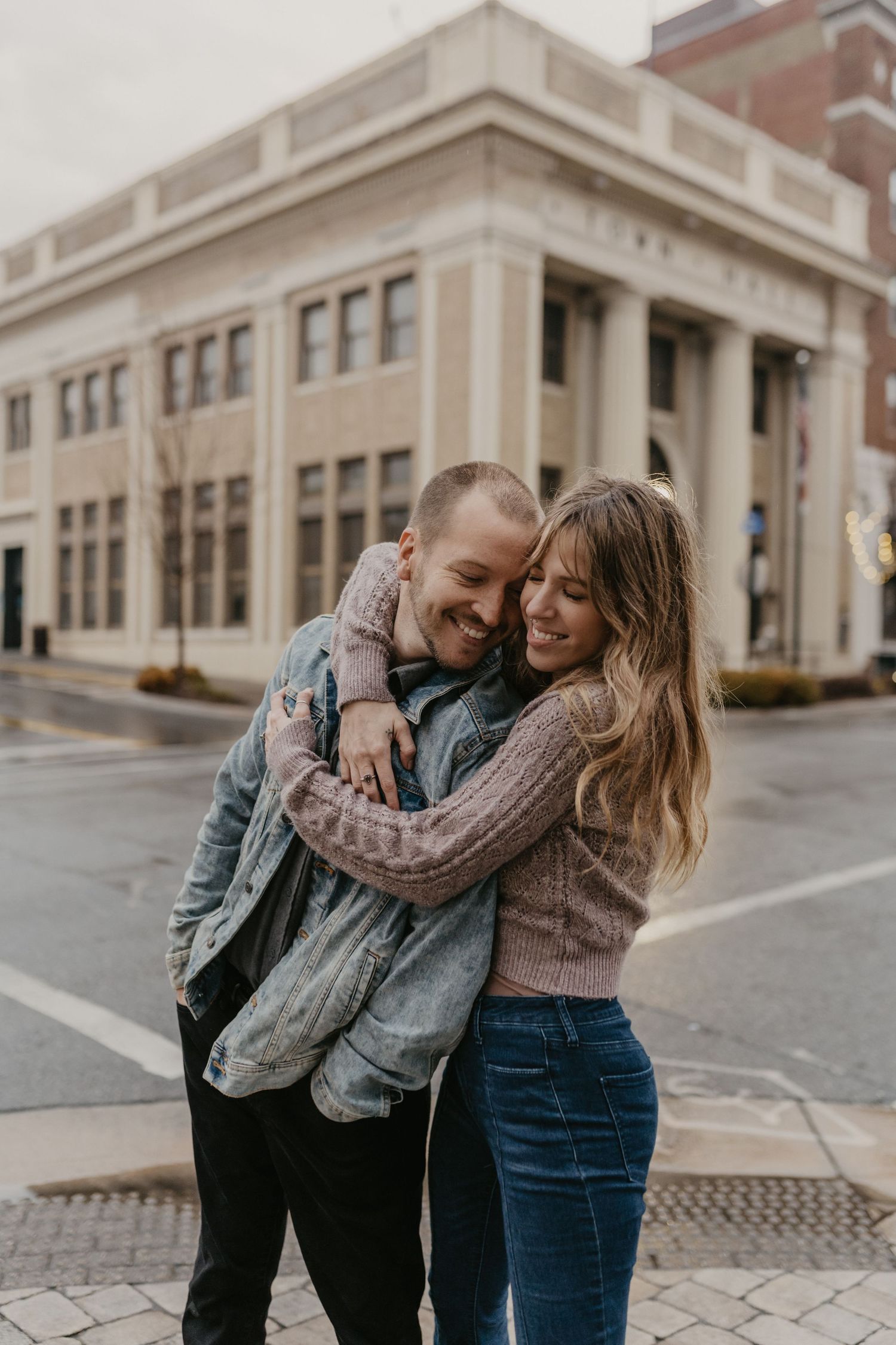 engaged couple posing in the a small town in north carolina