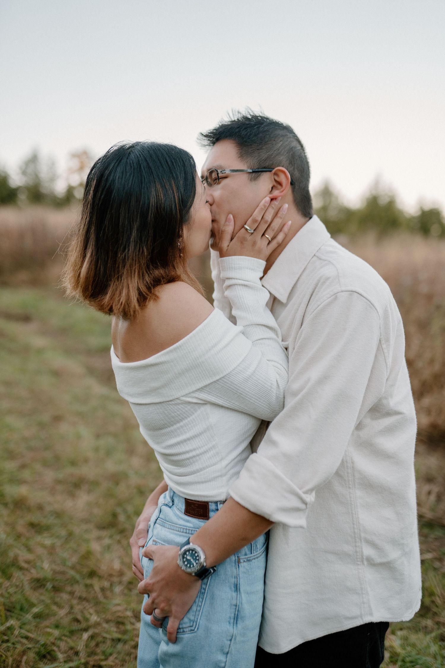 Two people kissing in a field in North Carolina