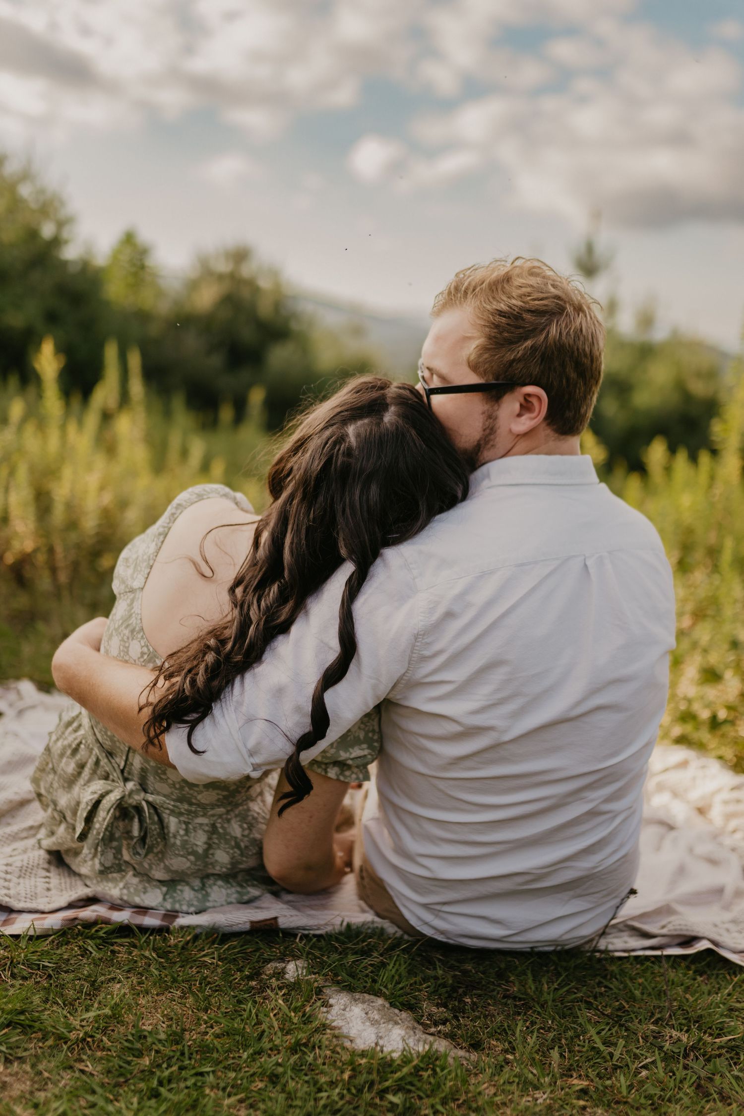 couple on a picnic in the mountains in north carolina for engagement pictures