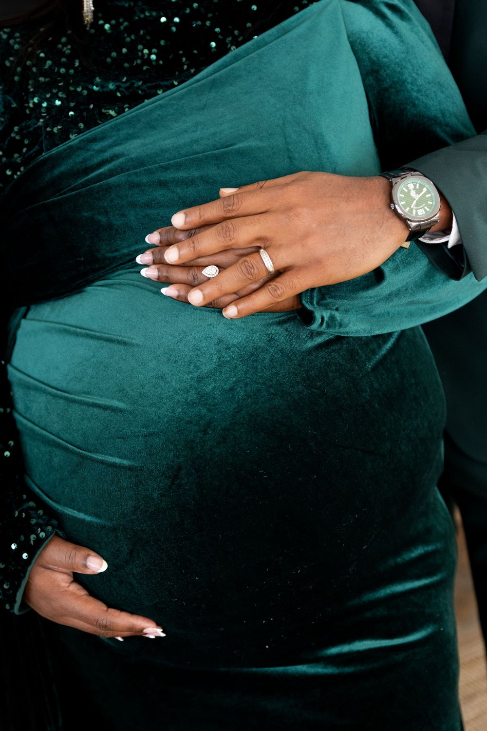 A series of photos showing hands cradling a pregnant belly wearing a dark teal green dress.