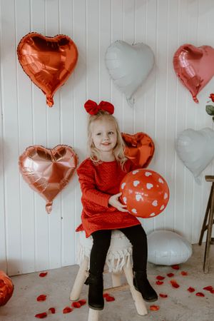Festive Valentine's scene with metallic heart balloons and red polka dot balloon decorations.