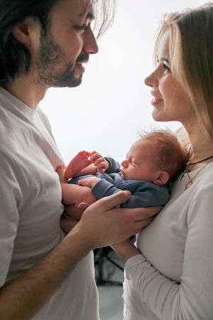 An intimate family moment sharing affection with their newborn baby.