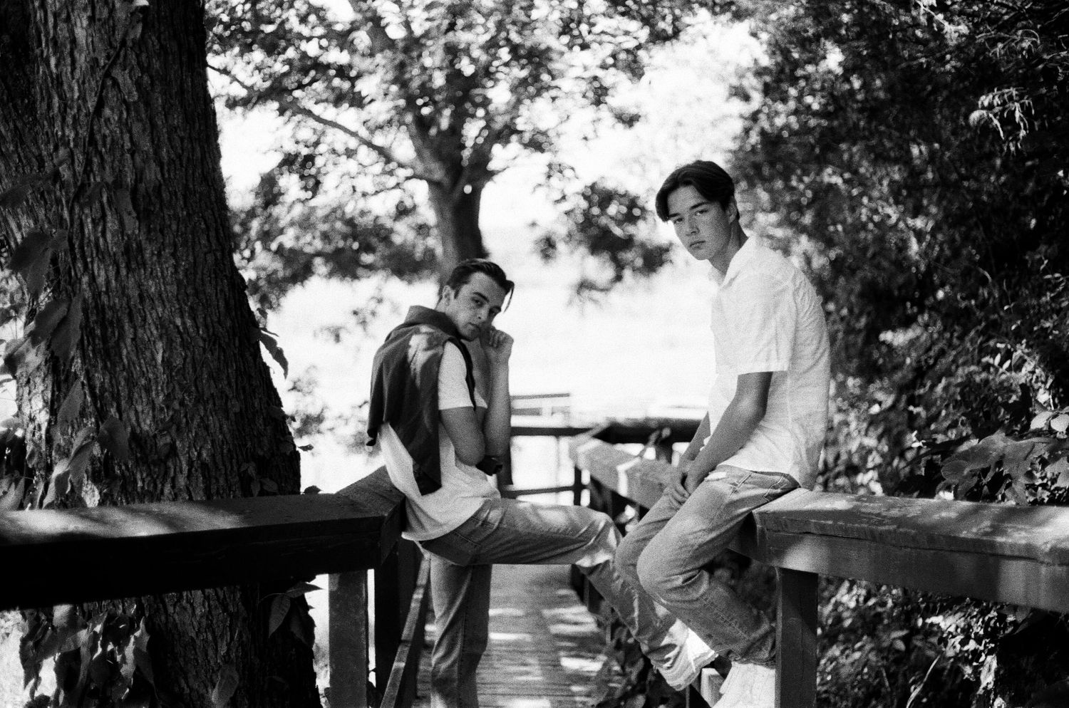 young men leaning on wooden bridge looking at camera, kansas city portrait photographer