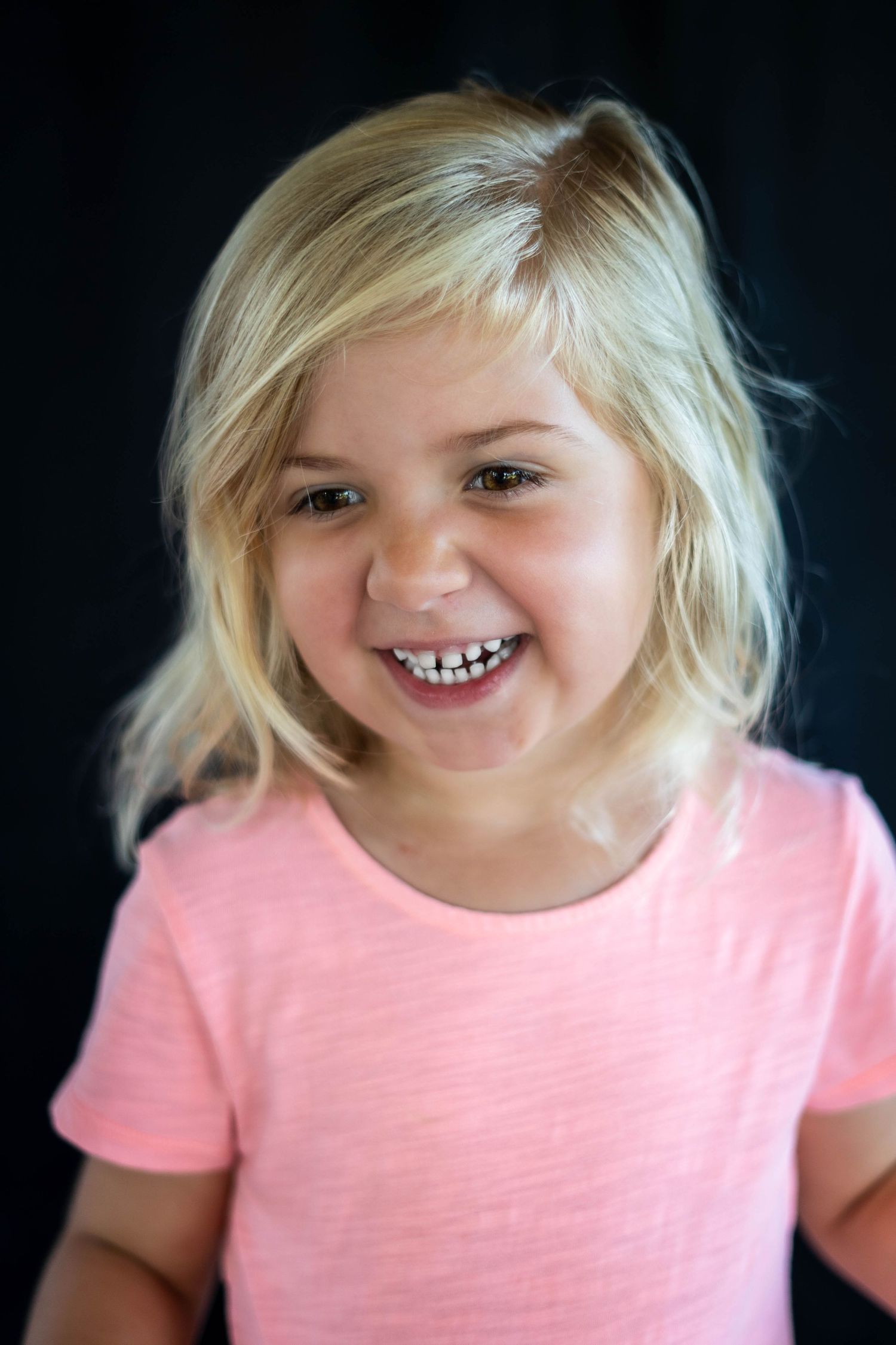 Smiling preschooler captured mid-laugh in Space Coast school photo session.