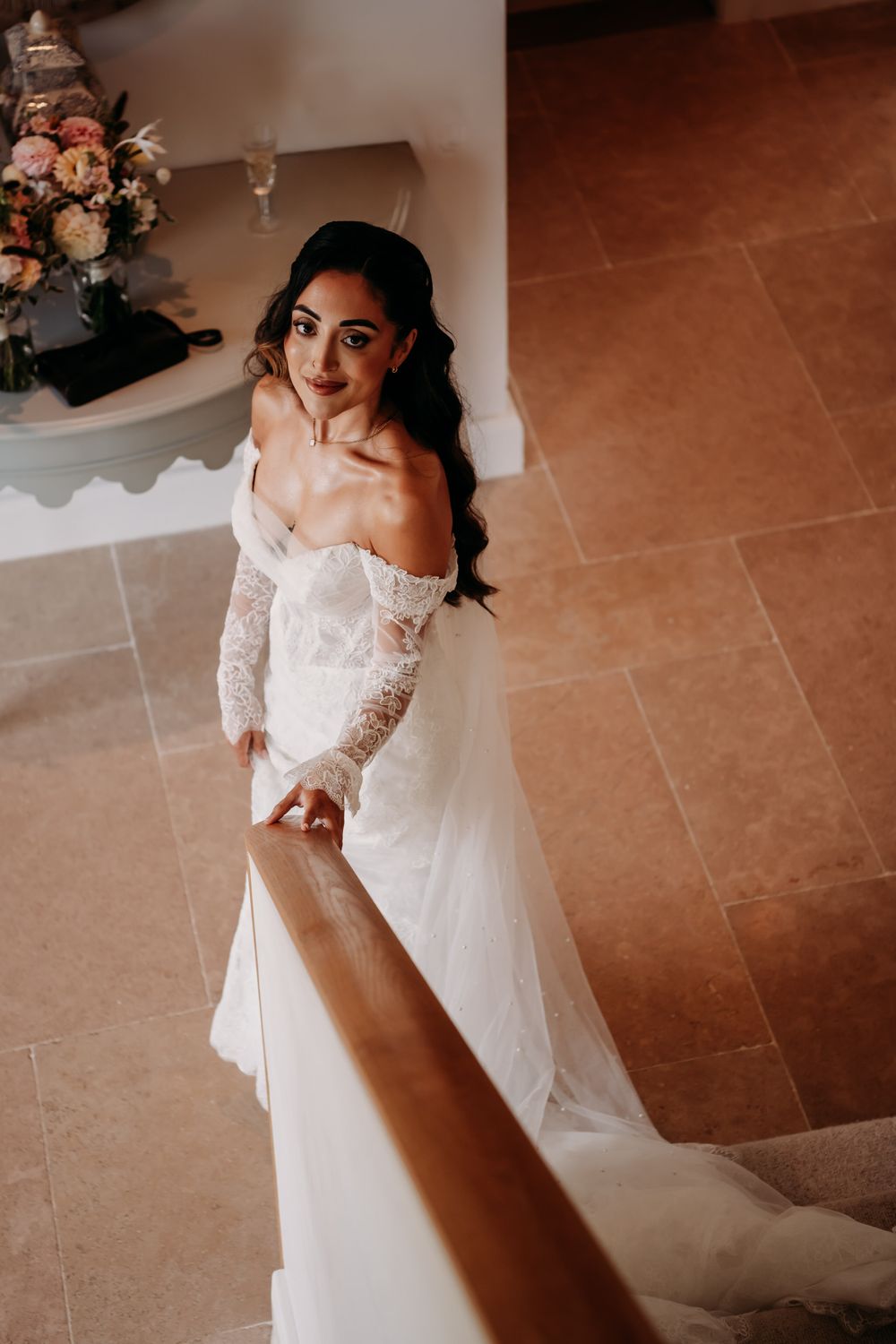 A series of intimate wedding dress detail shots showing delicate lace and flowing white fabric against a terracotta floor.