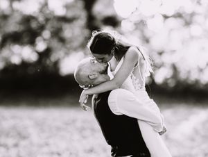 A romantic black and white photo sequence showing a couple dancing together in an outdoor setting.