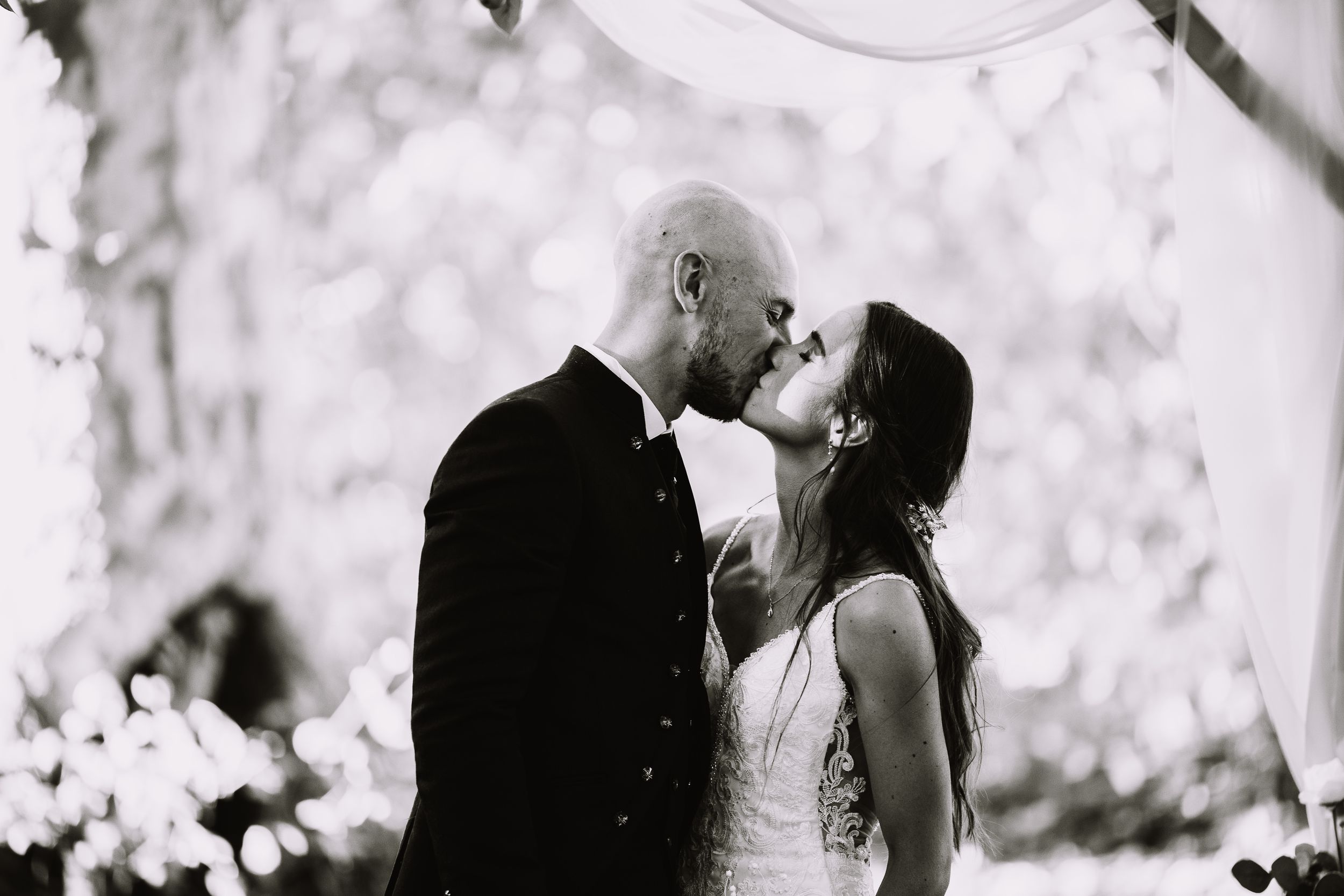 Black and white wedding photograph montage showing romantic moments between a couple on their special day.
