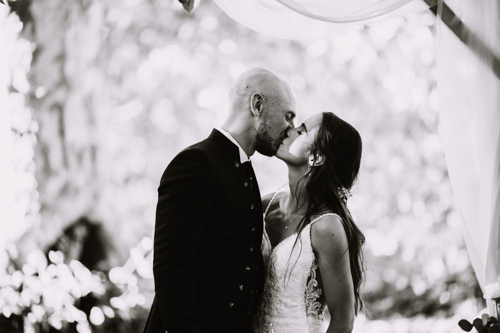 Black and white wedding photograph montage showing romantic moments between a couple on their special day.