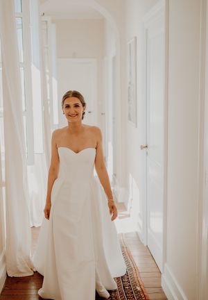 Four sequential bridal portraits showing a white wedding dress against a light interior hallway with natural window lighting.