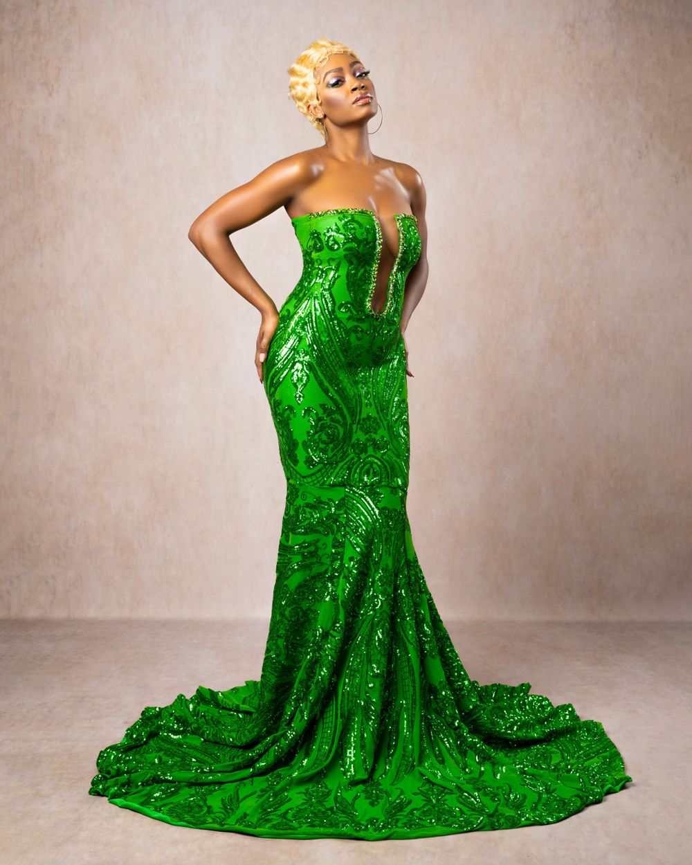 Stunning emerald green sequined gown with mermaid silhouette and dramatic train.