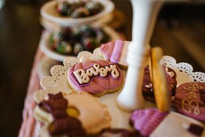 Close-up of dessert table decorations with candles and ornate details.