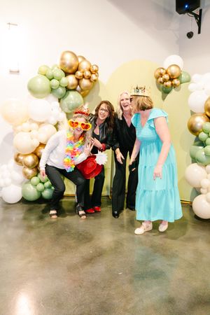 Celebration photos with balloon arches and people in formal attire posing together.