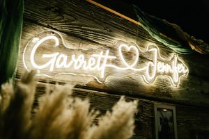 Decorative neon sign lighting creating an ambient glow against a dark wooden background.