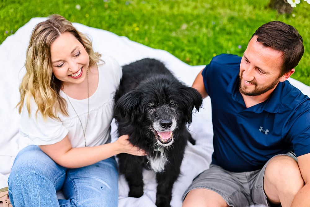 A candid image of a couple and their old dog in their celebration of life photoshoot/ session.