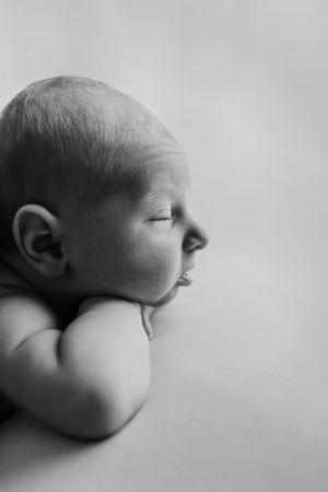 Black and white close-up profile view of a sleeping newborn baby against a light background during Tampa newborn photos