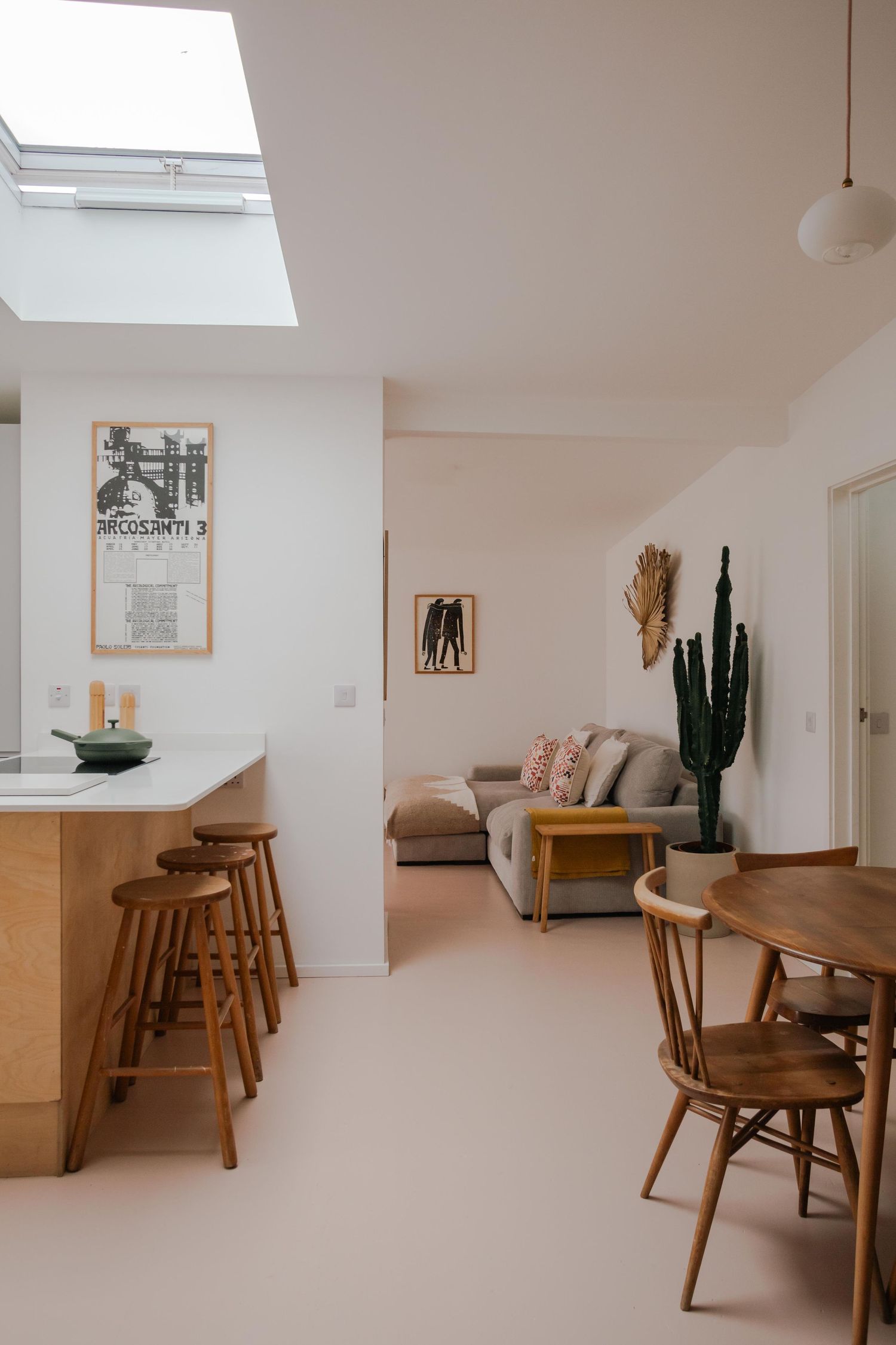 Modern open-plan kitchen with mid-century furniture accents and natural light in Cornwall.