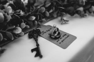 Vintage key and ring on card with greenery in black and white.