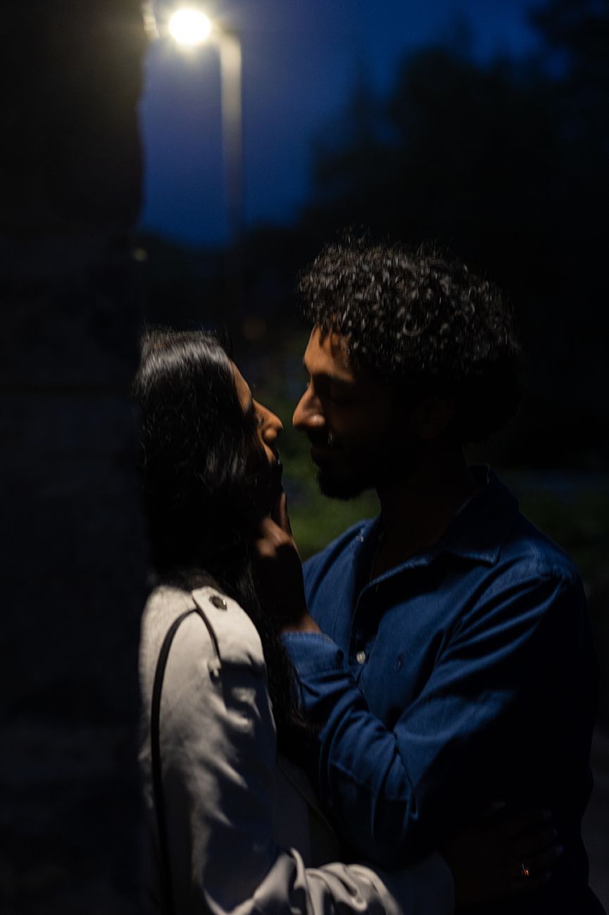 couple having an intimate moment in the late afternoon under a street lamp in Galway