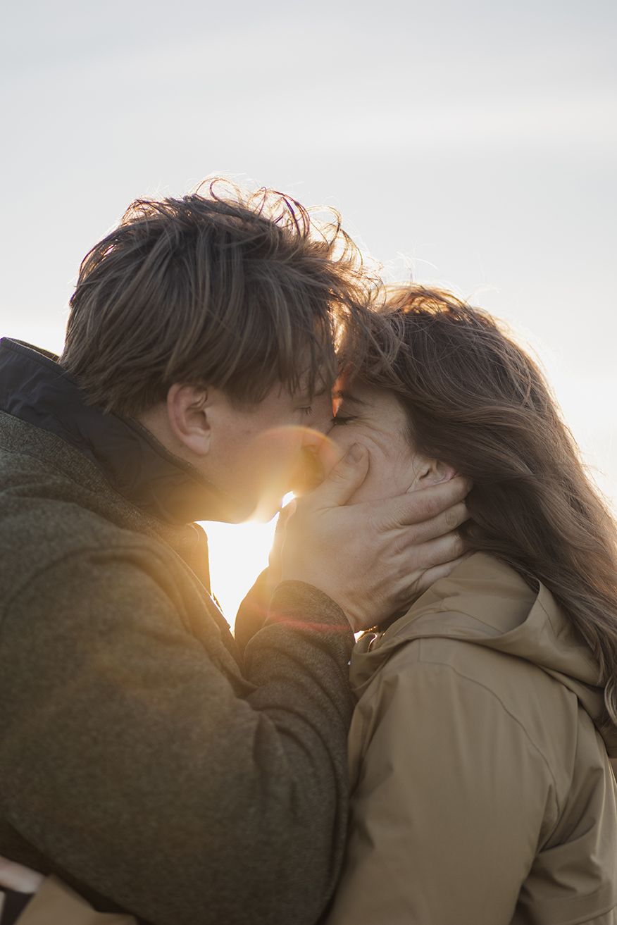 couple standing close to each other, kissing during their adventure photo session in beautiful Connemara national park