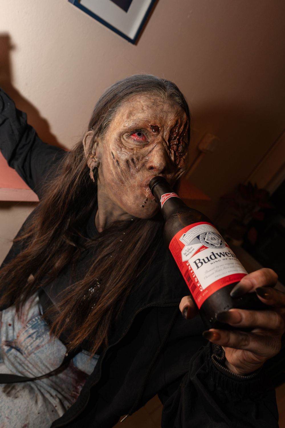 Zombie eating a pizza.