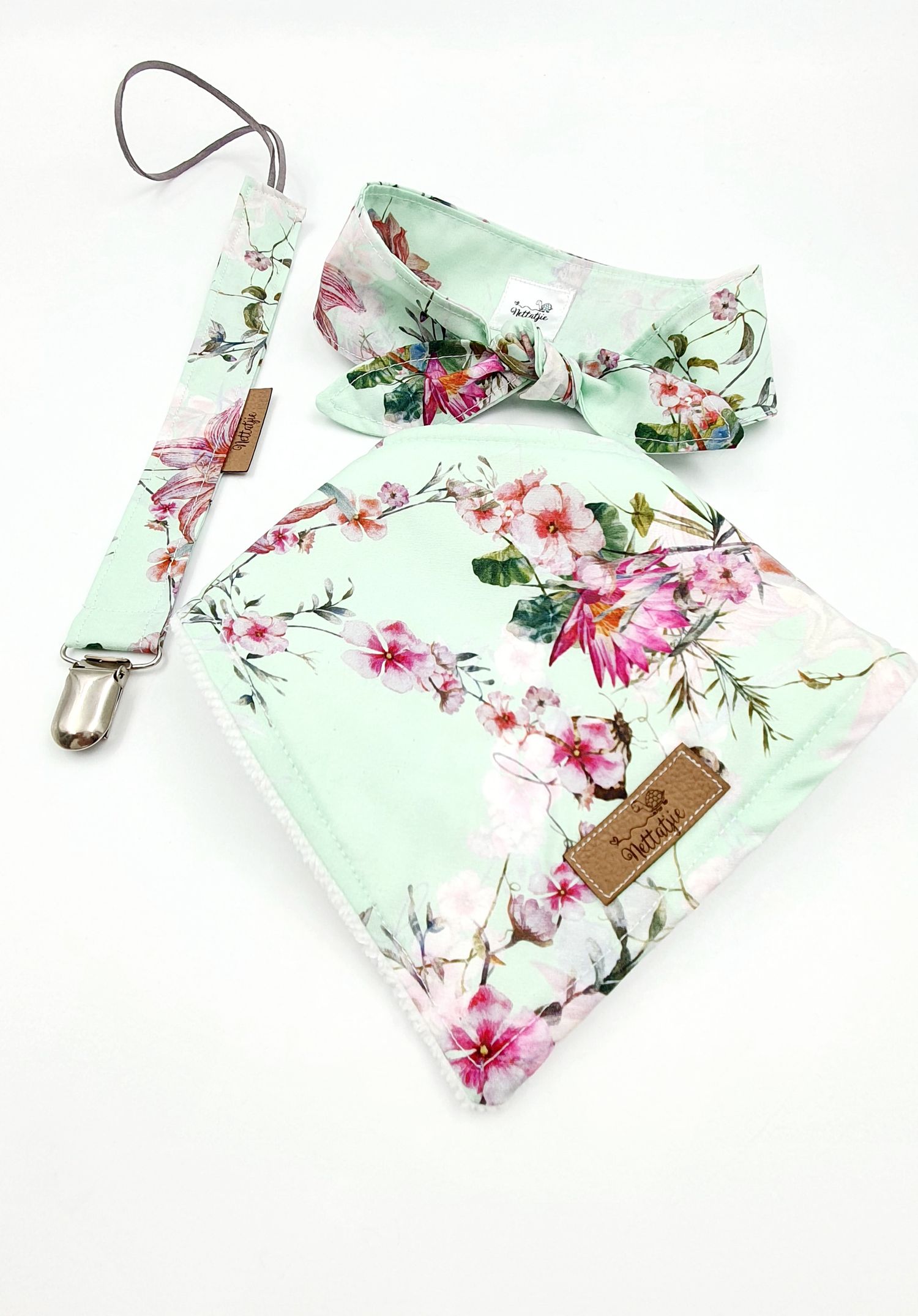 Mint green floral baby set with bandana bib, bow headband, and pacifier clip featuring pink cherry blossom print.