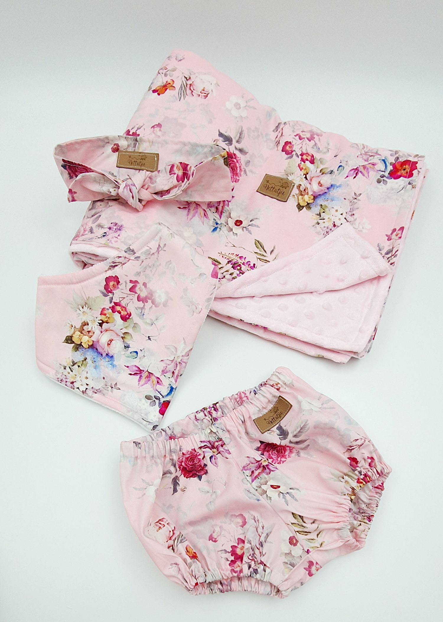 Pink floral baby gift set including blanket, headband, bib, and bloomers with minky dot fabric accent.