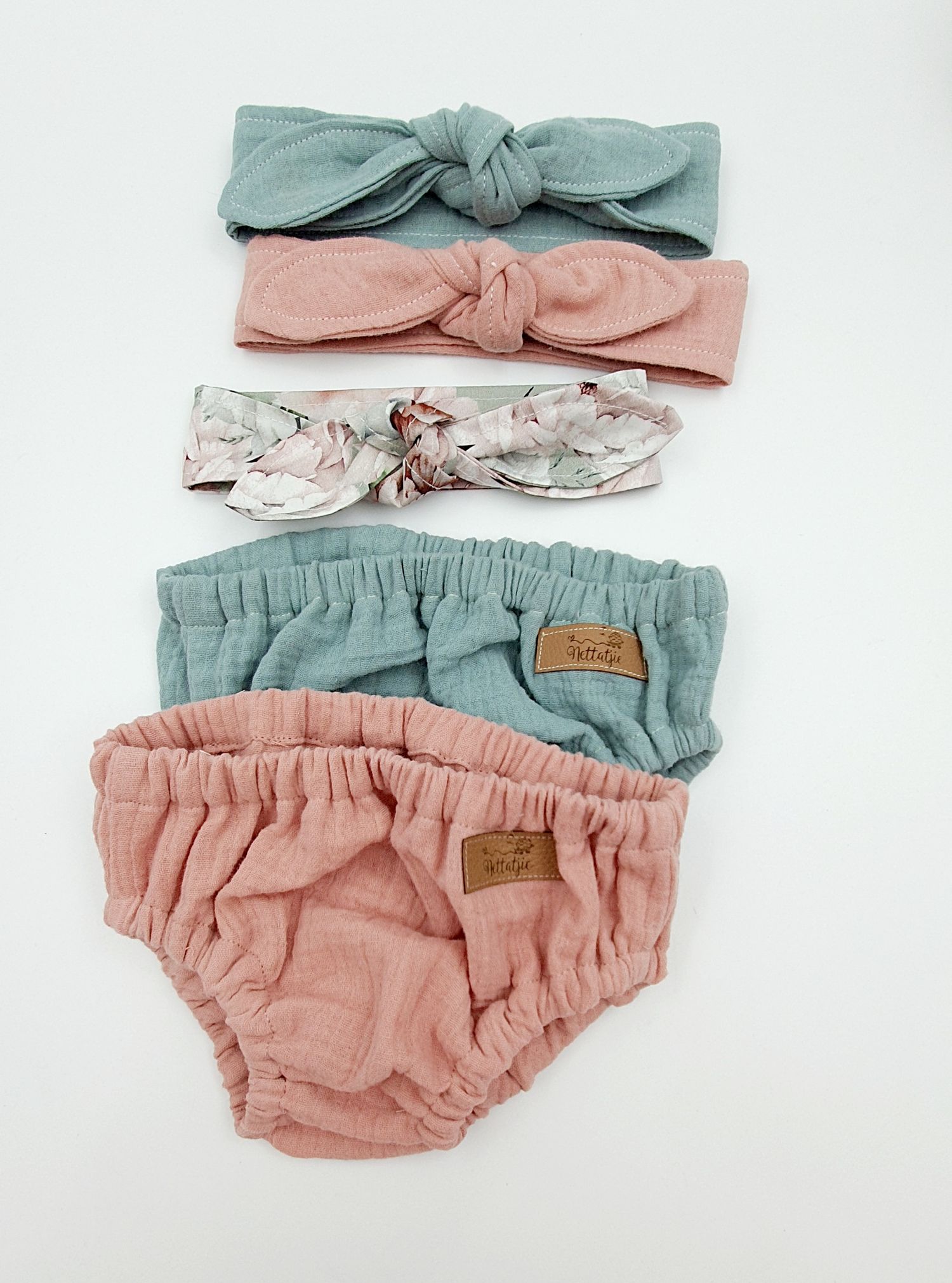 Baby girl set with sage green and pink muslin bloomers, knotted headbands in sage, pink, and floral print.