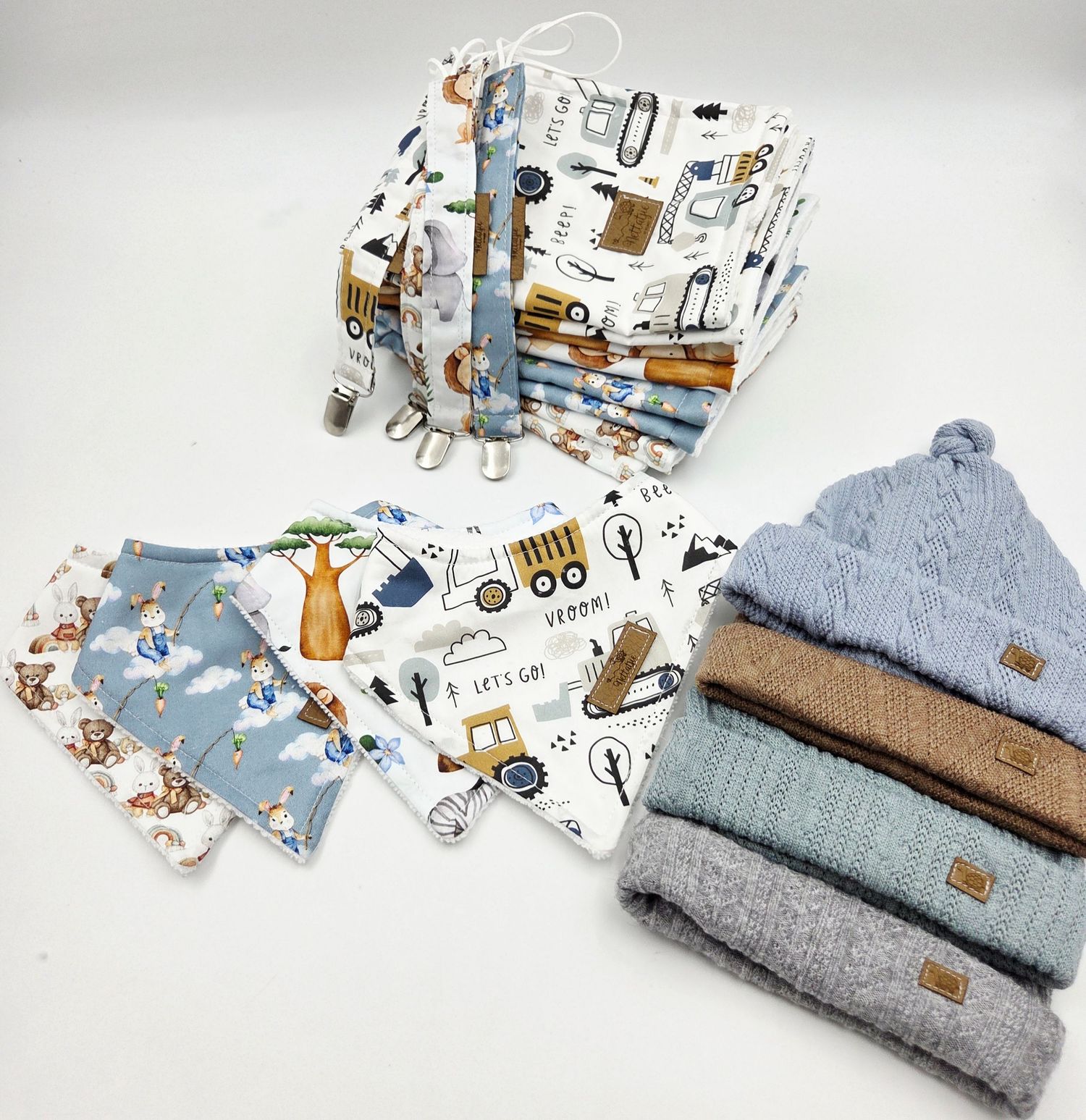 Construction themed baby accessories with blue knit hats and matching pattern fabric.