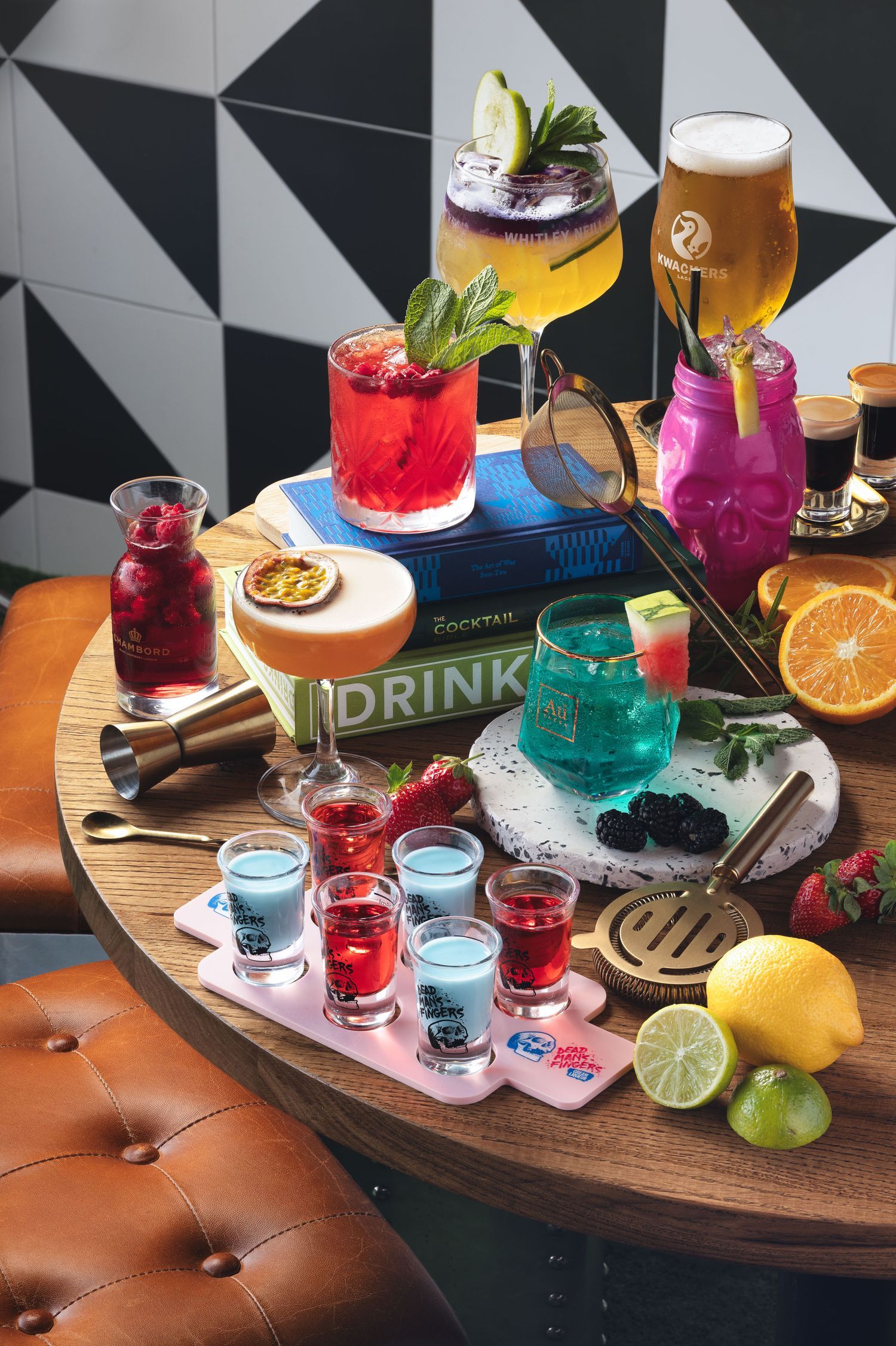 Colourful cocktail flatlay with shots, beer, mixed drinks and citrus garnishes on a wooden board, bar drinks menu photography Southampton
