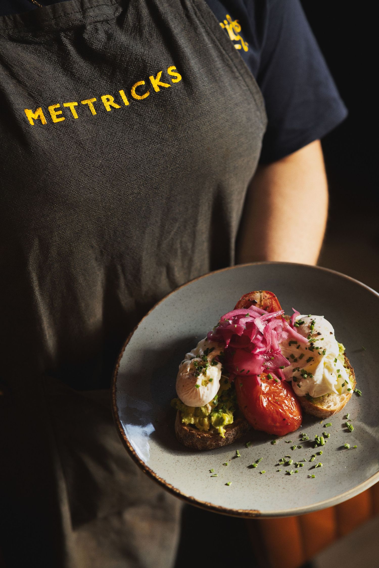Server presenting poached eggs brunch dish at Mettricks cafe Southampton, commercial restaurant food photography