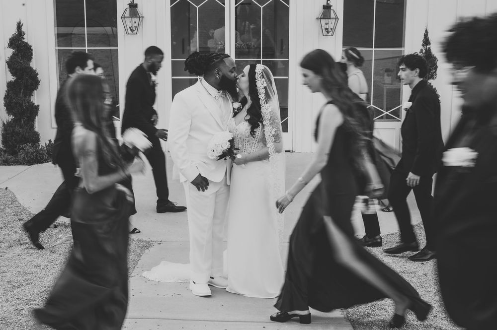 Wedding guests dance and celebrate on a dance floor at an elegant reception party.