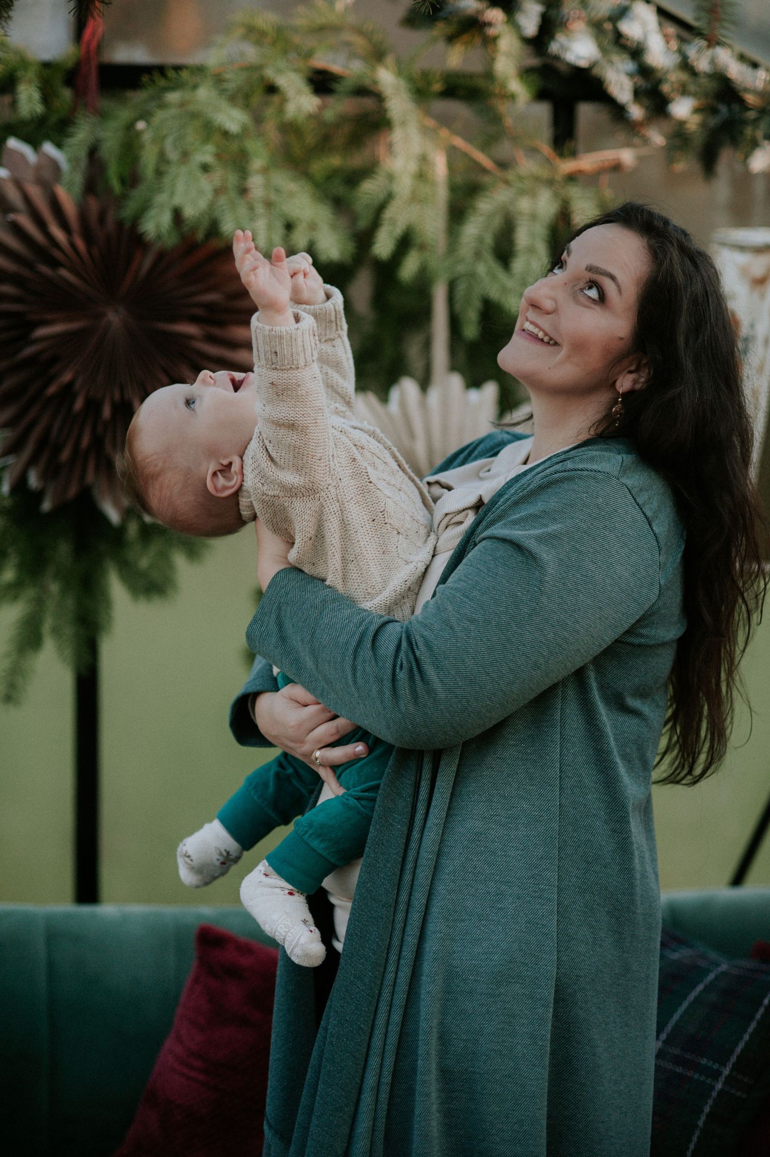 A series of candid lifestyle photos showing joyful interactions between a parent and baby in a green outdoor setting.