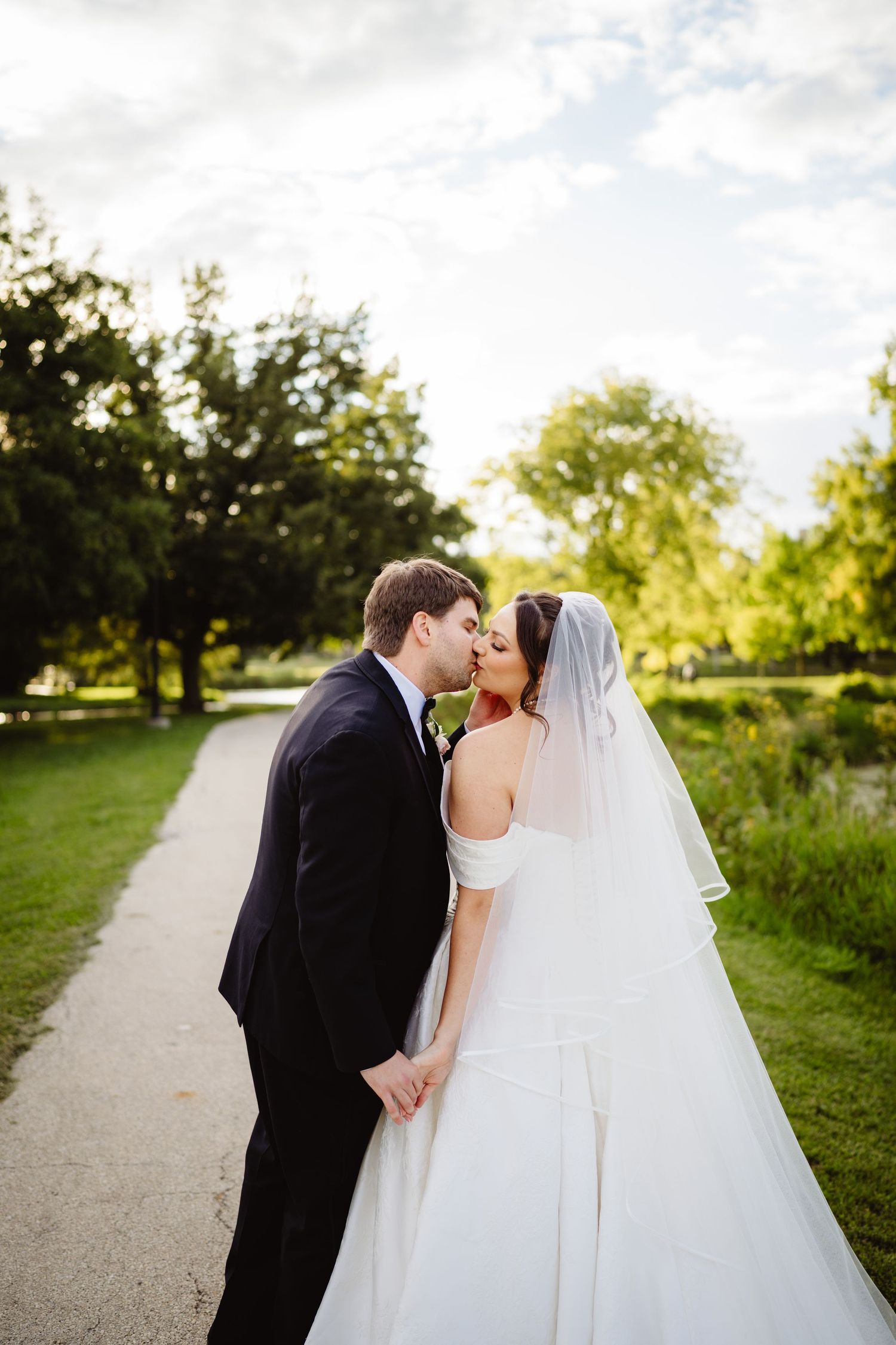 A romantic outdoor wedding portrait sequence shows the couple sharing kisses along a sunlit pathway.