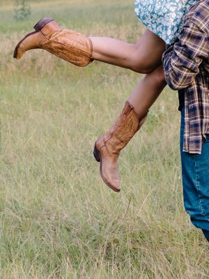 Three connected photos show brown leather cowboy boots kicking up in a grass field against a plaid shirt and jeans.
