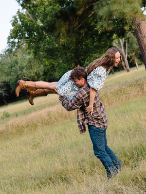 A playful series of someone dancing and spinning in a grassy field wearing a plaid shirt and jeans.