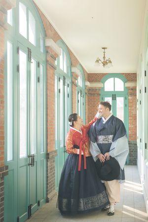 Bright hallway with mint green doors and windows in a historic Korean building.