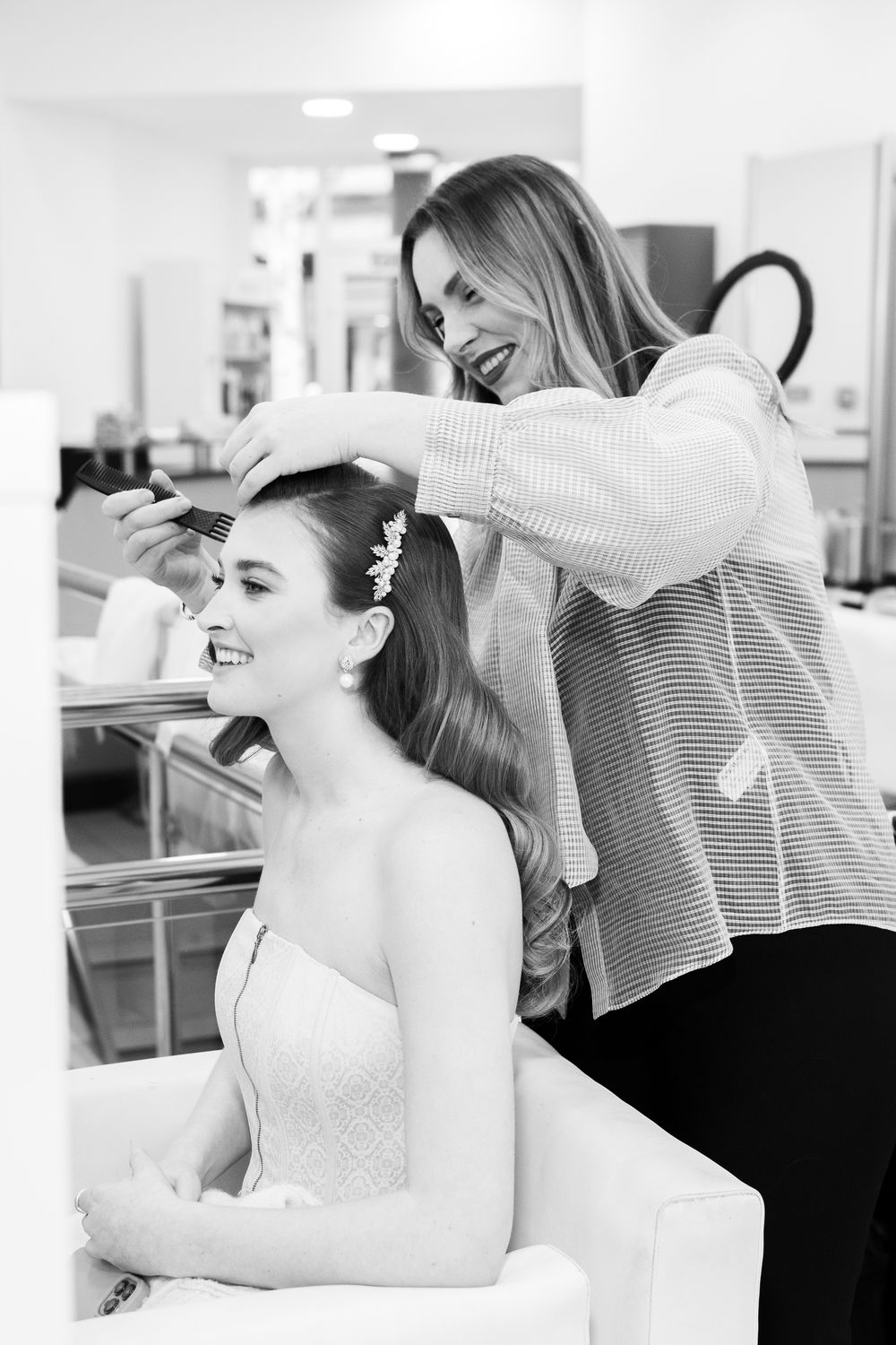 A hairstylist prepares a bride for a wedding in Cambridge