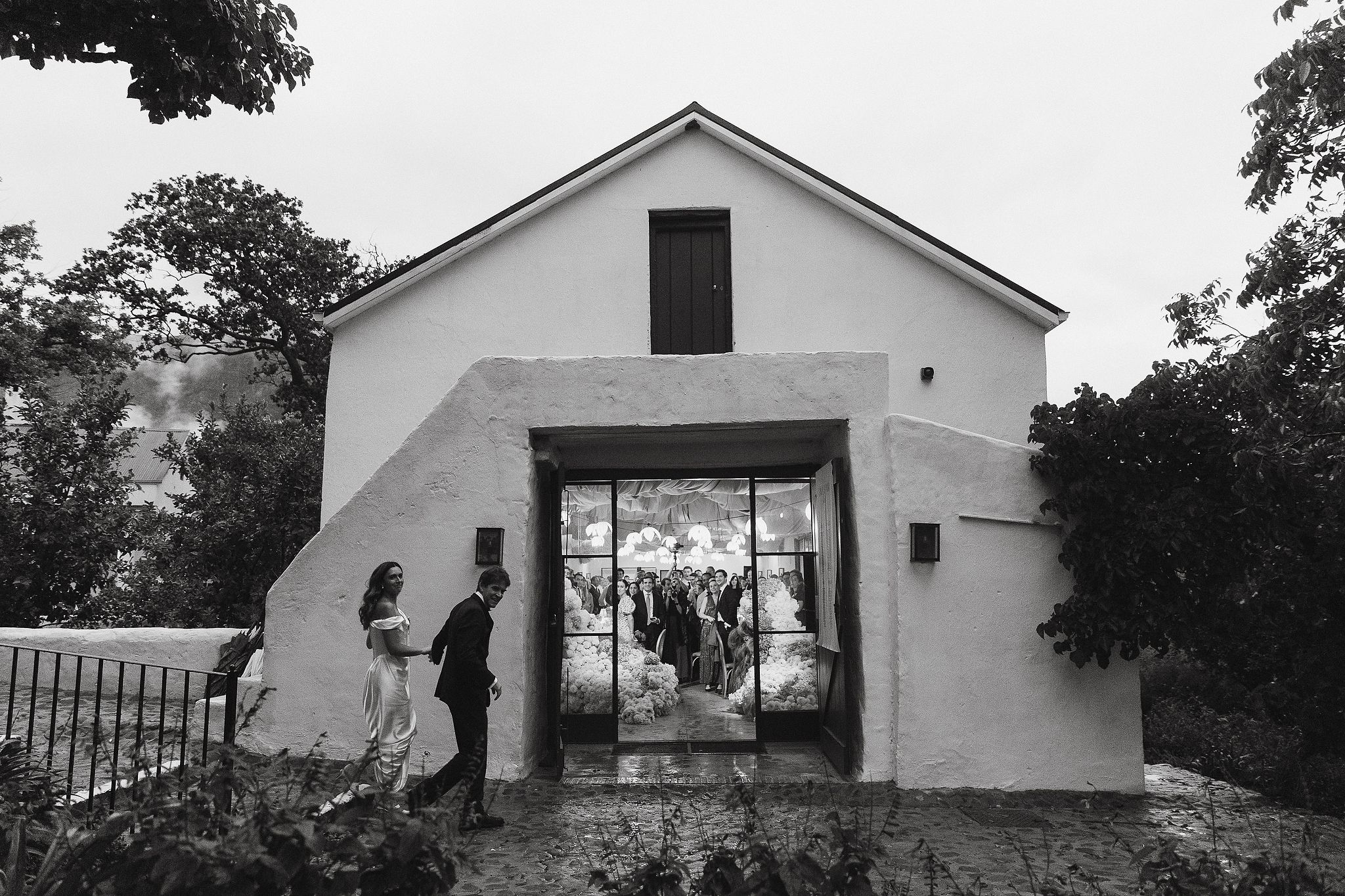 Bride and groom entering their wedding reception at La Cotte