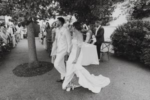 Bride and groom entering their outdoor wedding reception at La Cotte