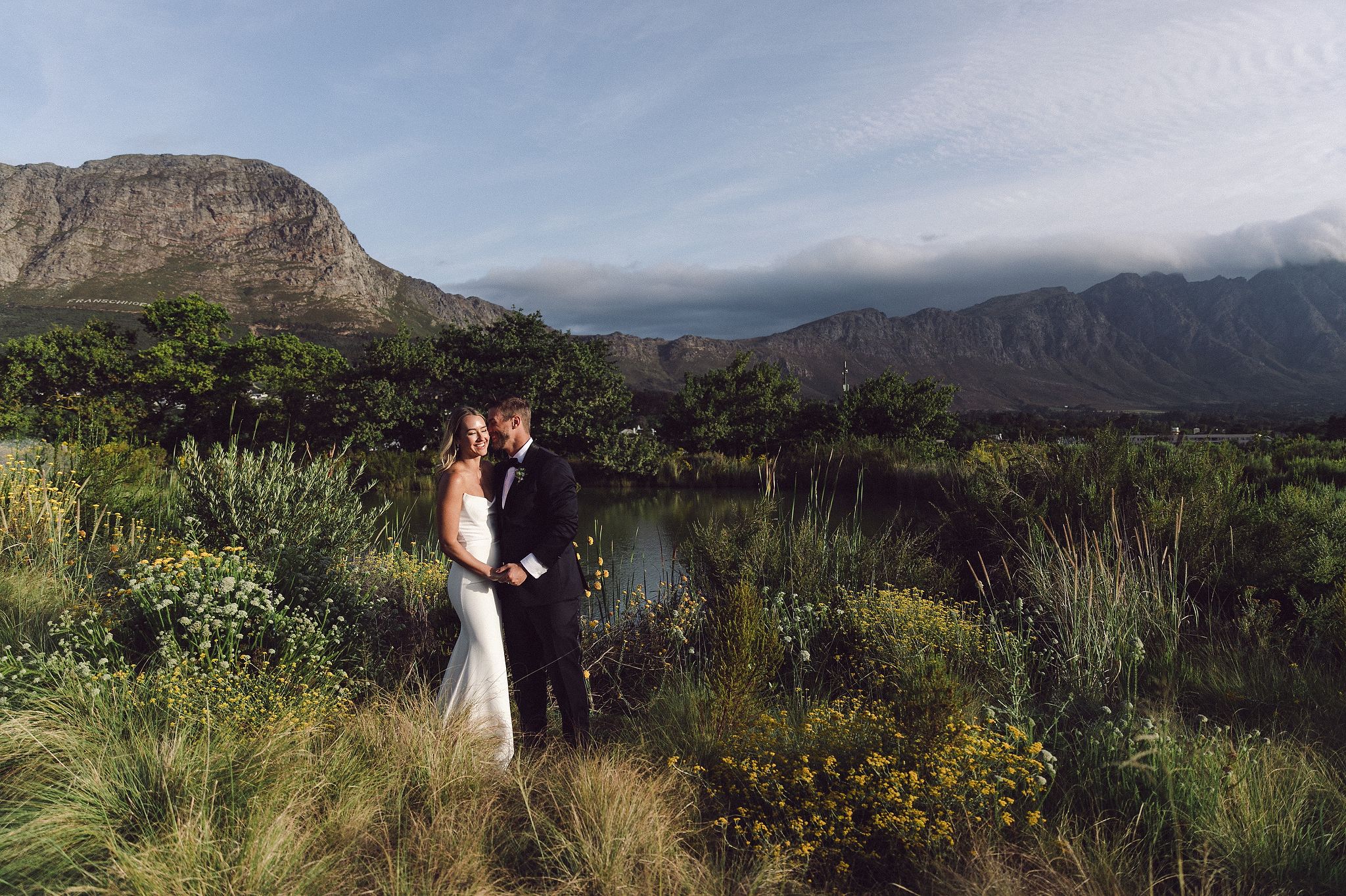 Bride and groom portraits at La Cotte in Franschhoek with mountain views