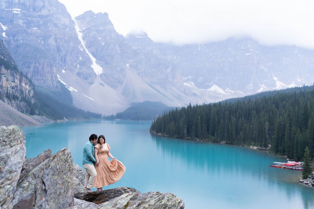 A stunning panorama of Moraine Lake in Banff National Park shows vibrant turquoise waters surrounded by majestic peaks.