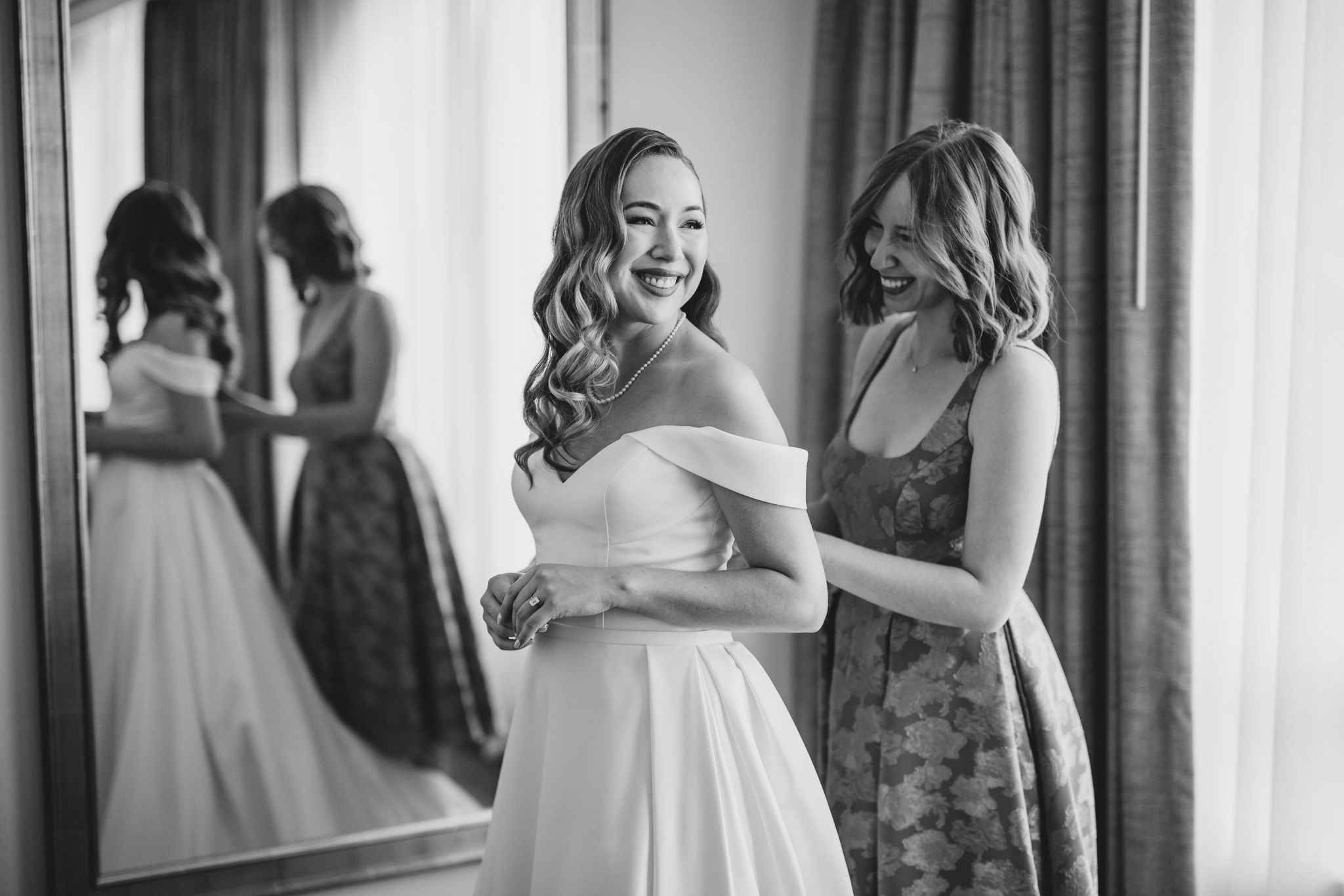 Candid wedding preparation moments captured in black and white photography.